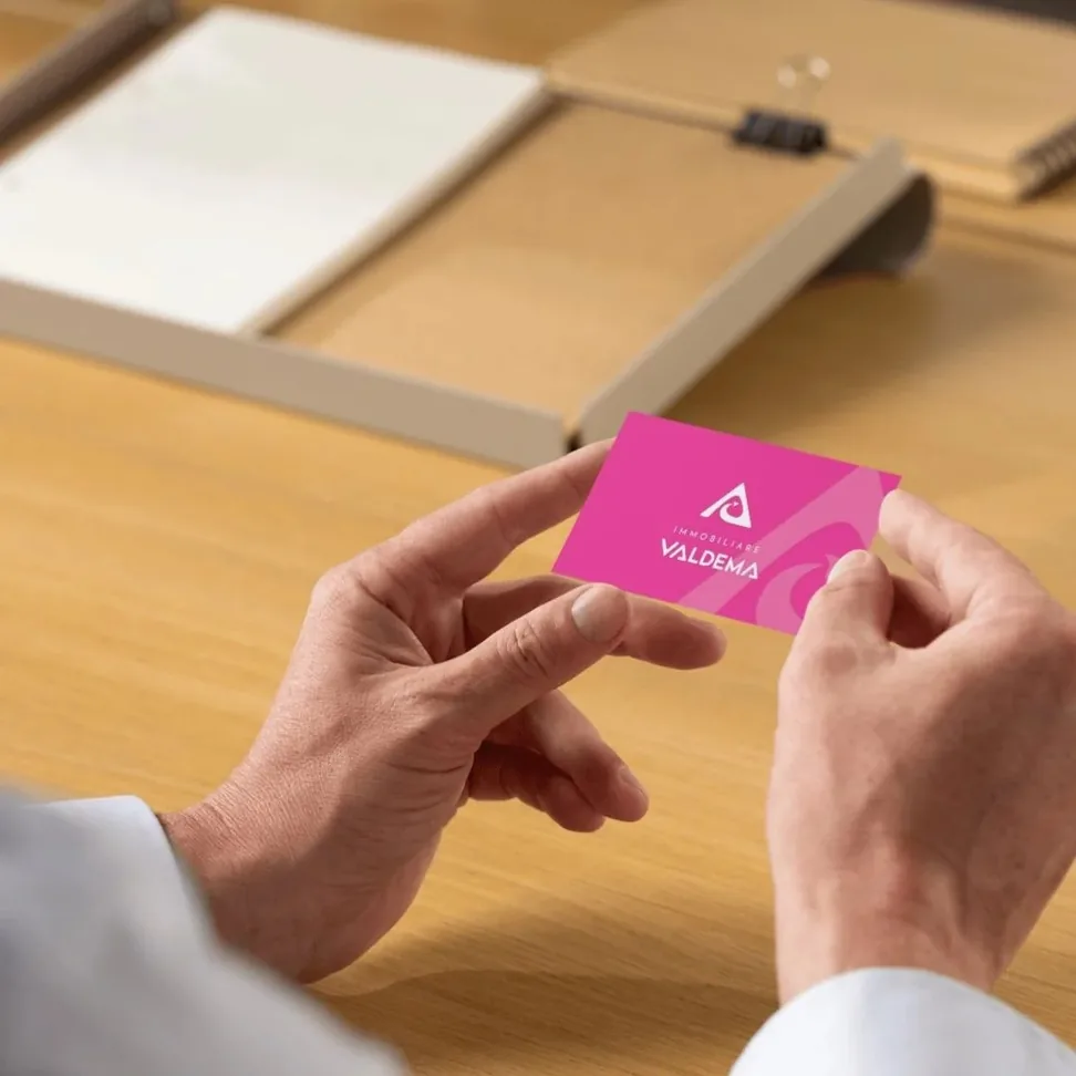 Business card from a brand identity project, held in hand